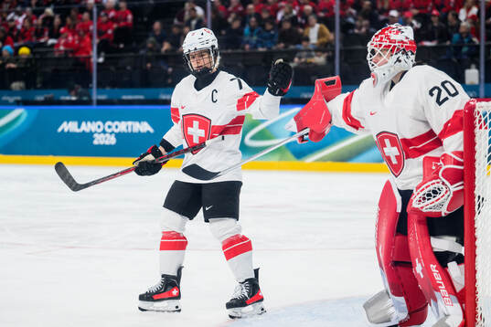 Lara Stalder and goaltender Andrea Braendli of Switzerland