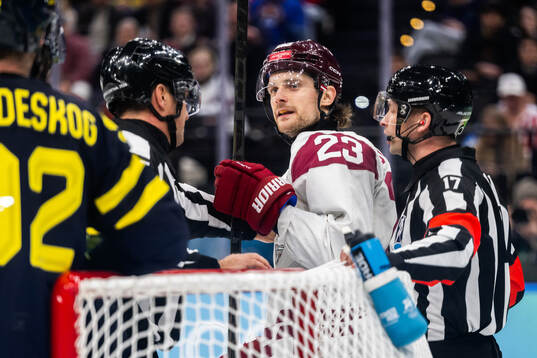 Teodors Blugers of Latvia reacts in the men's ice hockey