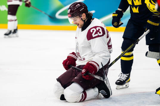 Teodors Blugers of Latvia looks dejected in the men's ice