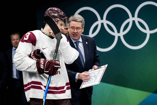 Alberts Smits and head coach Harijs Vitolins of Latvia in