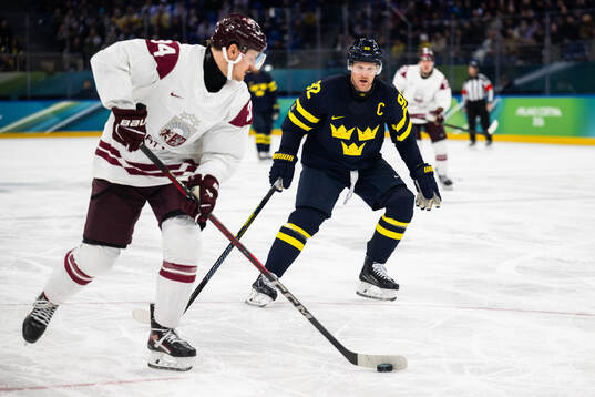 Eduards Tralmaks of Latvia and Gabriel Landeskog of Sweden