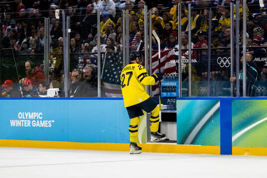 Hampus Lindholm of Sweden receives a penalty in the men's