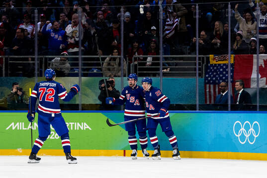 Dylan Larkin and Charlie McAvoy of USA celebrate