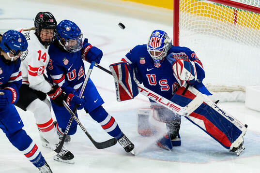 Renata Fast of Canada against Cayla Barnes and goaltender