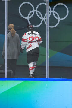 Erin Ambrose of Canada leaves the ice with an injury in the