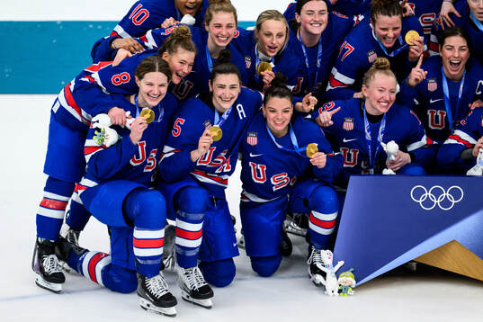 Megan Keller of USA celebrates with her gold medal