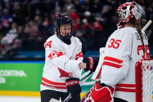 Renata Fast and goaltender Ann-Renee Desbiens of Canada in