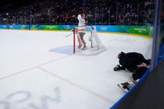 Erin Ambrose of Canada in pain in the women's ice hockey