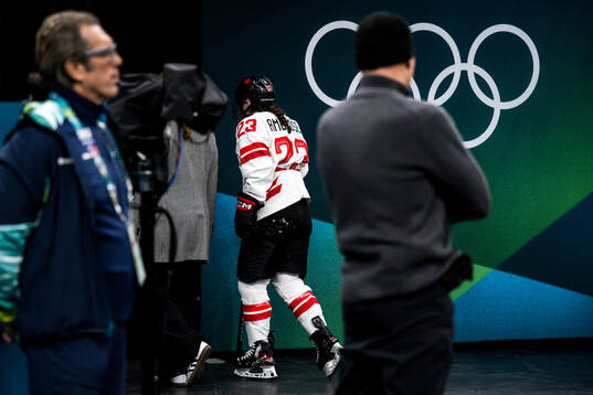 Erin Ambrose of Canada leaves the ice with an injury in the