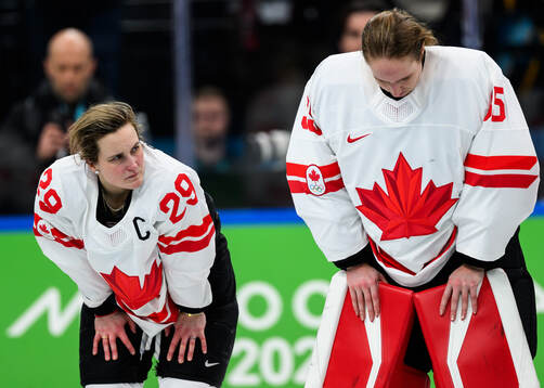 Marie-Philip Poulin and goaltender Ann-Renee Desbiens of