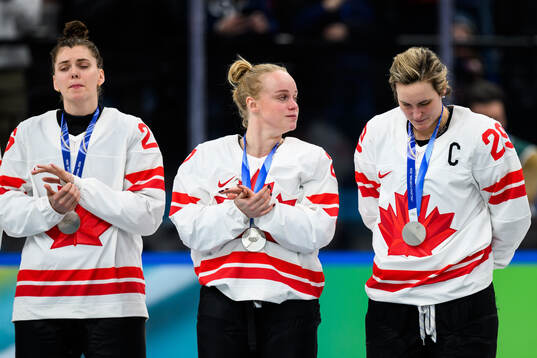 Emily Clark, Emma Maltais and Marie-Philip Poulin of Canada