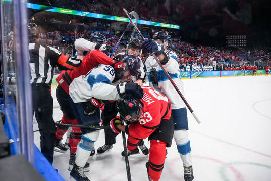 Rasmus Ristolainen of Finland and Brad Marchand of Canada