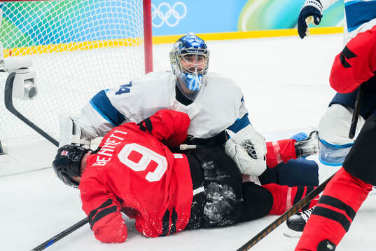 Sam Bennett of Canada and goaltender Juuse Saros of Finland