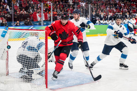 Nick Suzuki of Canada against Sebastian Aho and Henri