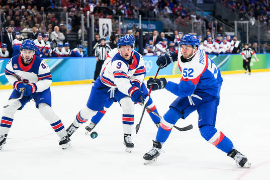 Quinn Hughes and Jack Eichel of USA with Martin Marincin of