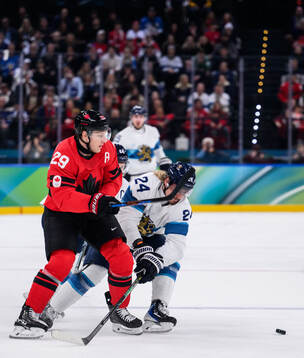 Nathan MacKinnon of Canada against Roope Hintz of Finland