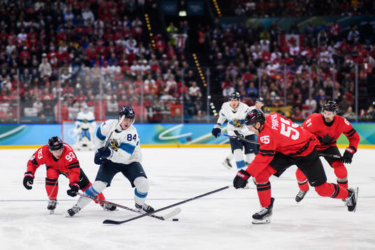 Kaapo Kakko of Finland against Mitch Marner, Colton Parayko