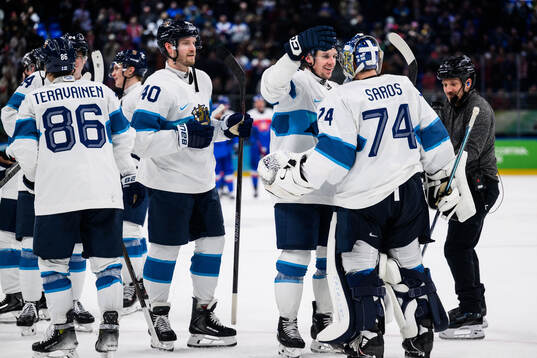 Erik Haula and goaltender Juuse Saros of Finland celebrate