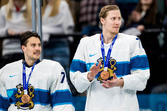 Niko Mikkola of Finland with their bronze medals at the