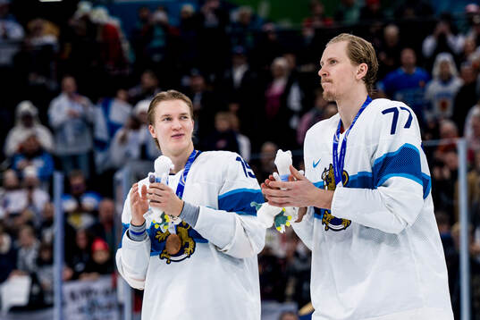 Anton Lundell and Niko Mikkola of Finland celebrate with