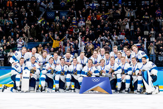Players of Finland celebrate with their bronze medals at