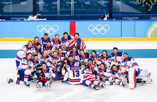 Players of USA celebrate with the shirt of Johnny Gaudreau