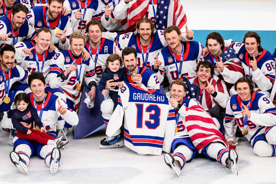 Players of USA celebrate with the shirt of Johnny Gaudreau