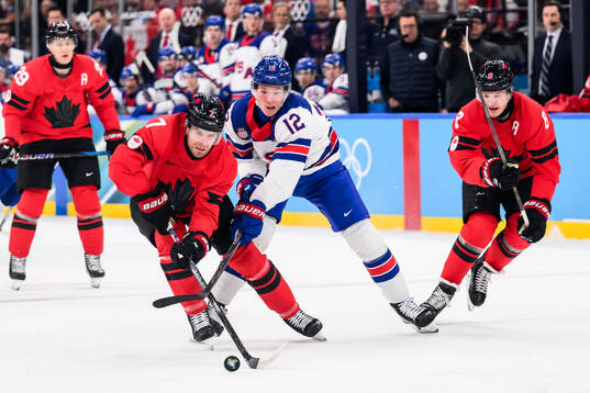 Matt Boldy of USA in action with Devon Toews and Cale Makar