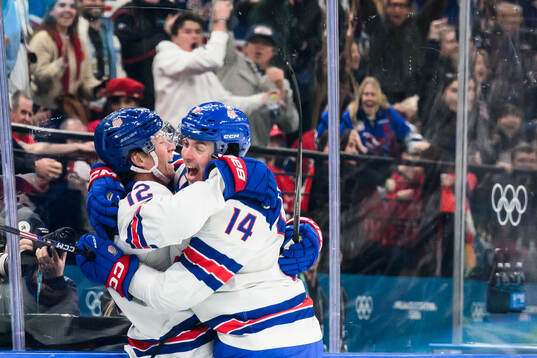 Matt Boldy and Brock Faber of USA celebrate