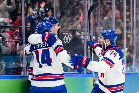 Matt Boldy, Brock Faber and Jaccob Slavin of USA celebrate