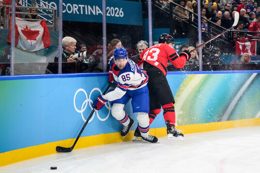 Jake Sanderson of USA and Mitch Marner of Canada in the
