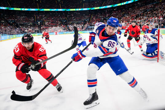 Brad Marchand of Canada and Jake Sanderson of USA in the