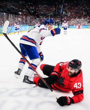 Matt Boldy of USA and Tom Wilson of Canada in the men's ice