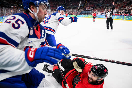 Charlie McAvoy and Matt Boldy of USA against Tom Wilson of