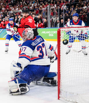 Nick Suzuki of Canada and goaltender Connor Hellebuyck of