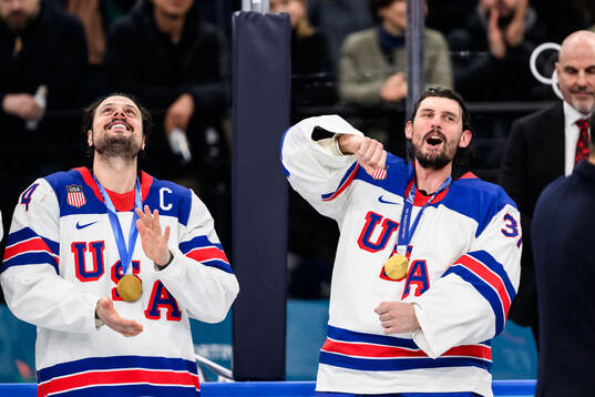 Auston Matthews and goaltender Connor Hellebuyck of USA