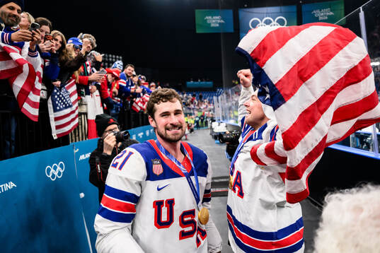 Dylan Larkin and Charlie McAvoy of USA celebrate