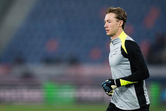Goalkeeper Mathias Dyngeland of Brann warms up