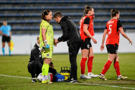 Goalkeeper Mariella El Sherif of Austria receives medicinal