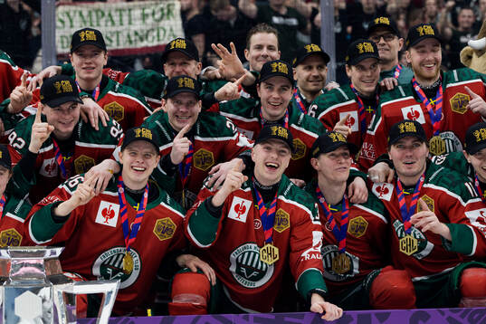 Players of Frölunda celebrate with the trophy