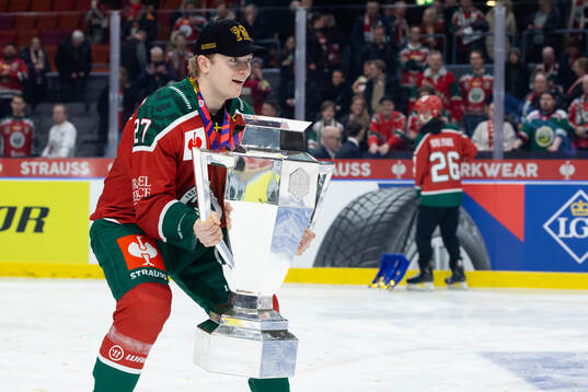 Theodor Niederbach of Frölunda celebrates with the trophy