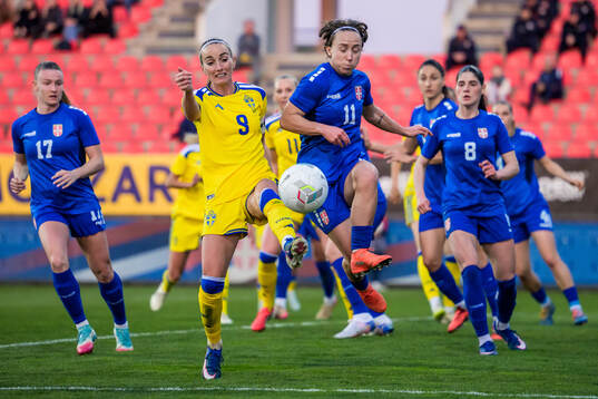 Kosovare Asllani of Sweden and Miljana Ivanovic of Serbia