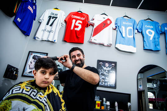 MFF-spelarnas frisörer. Aram Hassan klipper Benjamin Zandi