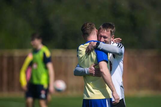 Injured player Dejan Kulusevski gets a hug from head coach