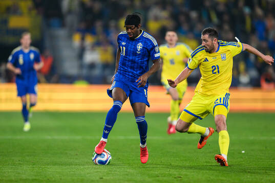 Anthony Elanga of Sweden and Ivan Kaliuzhnyi of Ukraine