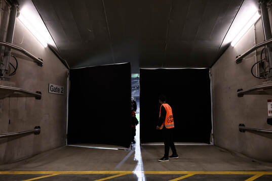 Stewards close the doors to the training pitch at a