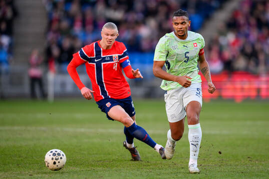 Erling Braut Haaland of Norway and Manuel Akanji of