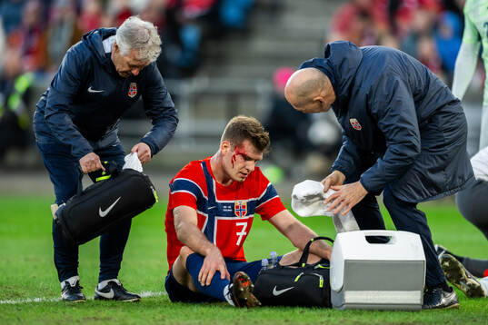 Alexander Sørloth of Norway receives medical attention