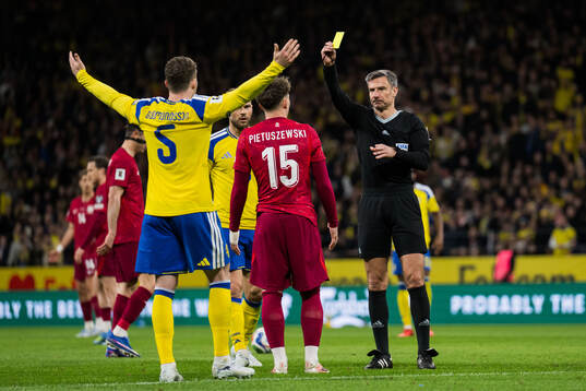 Referee Slavko Vincic and Oskar Pietuszewski of Poland