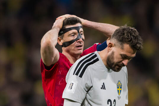 Robert Lewandowski of Poland and goalkeeper Kristoffer